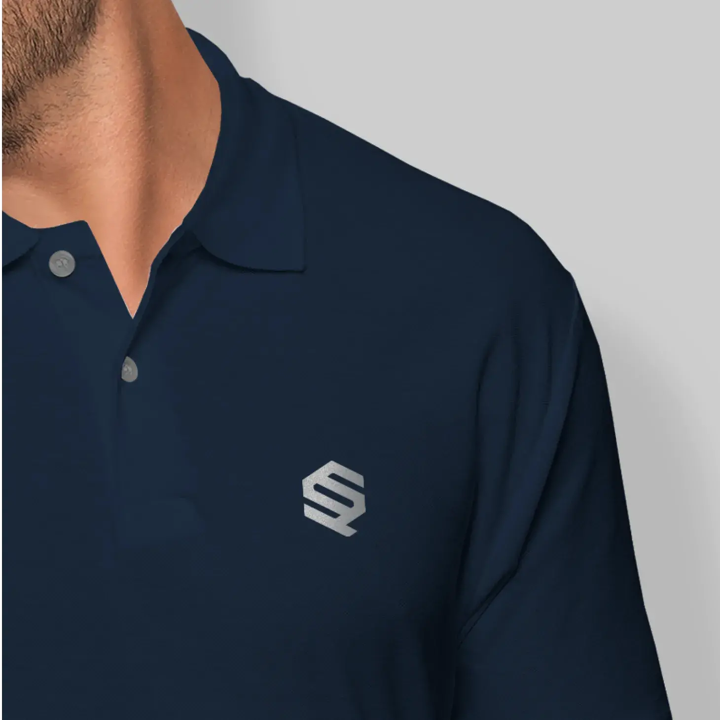 Navy polo with silver QS Partners logo