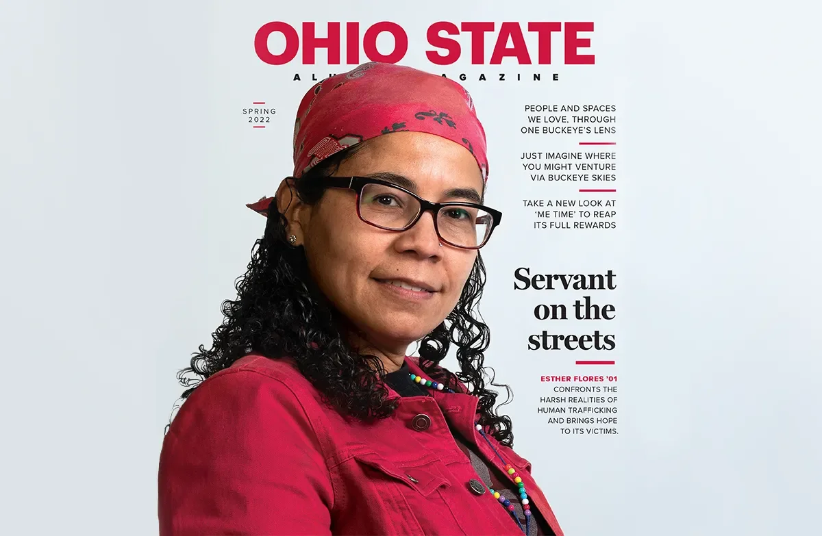 the cover of an ohio state alumni magazine with a woman in a red button up shirt and red baseball cap on