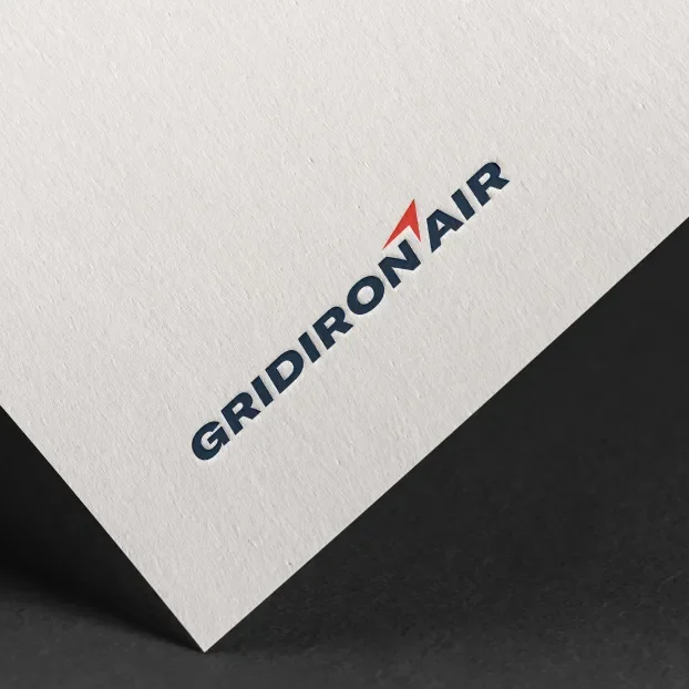 Gridiron Air logo printed on a tilted white textured paper.