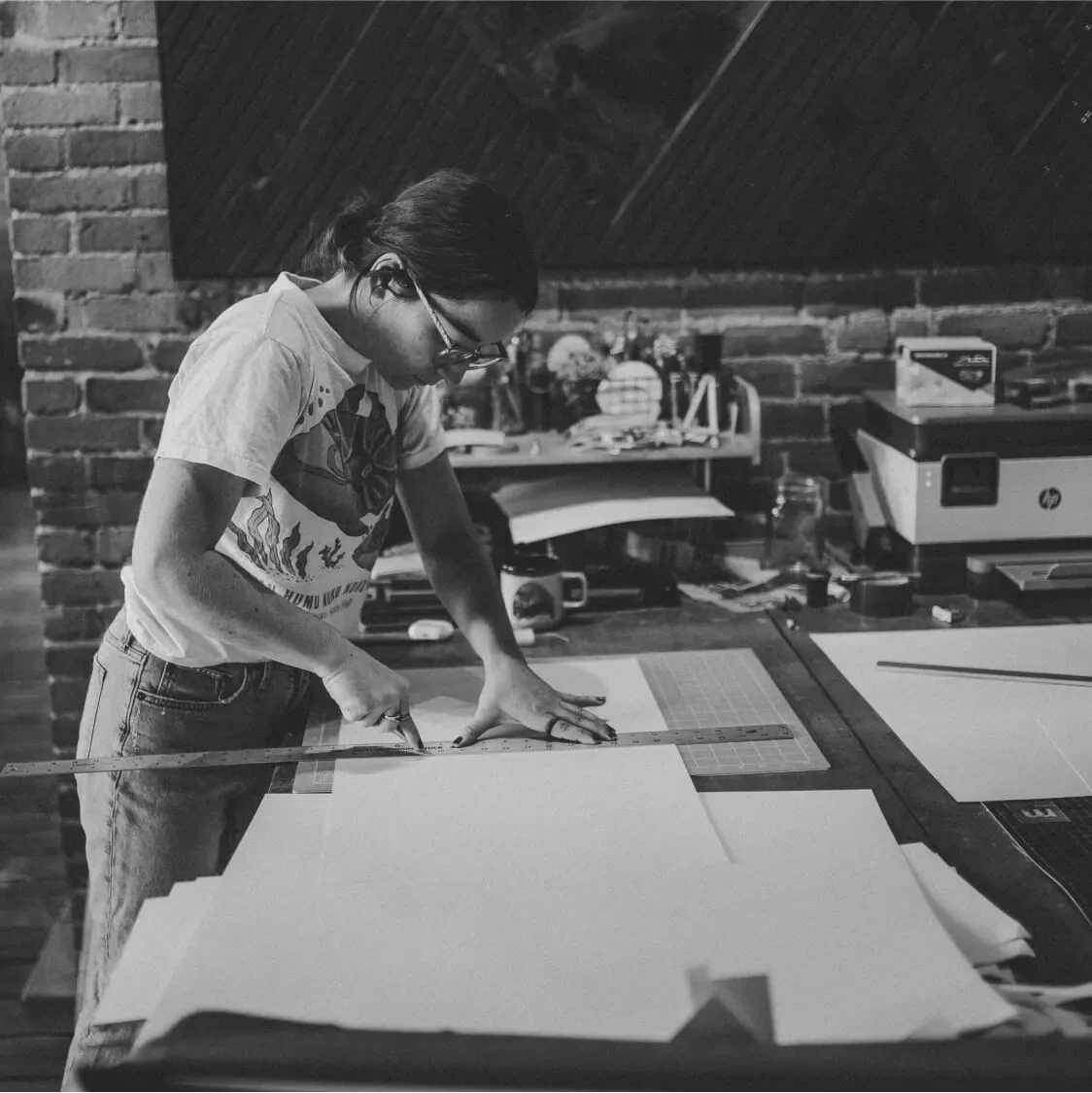 Black and white shot of paper being cut