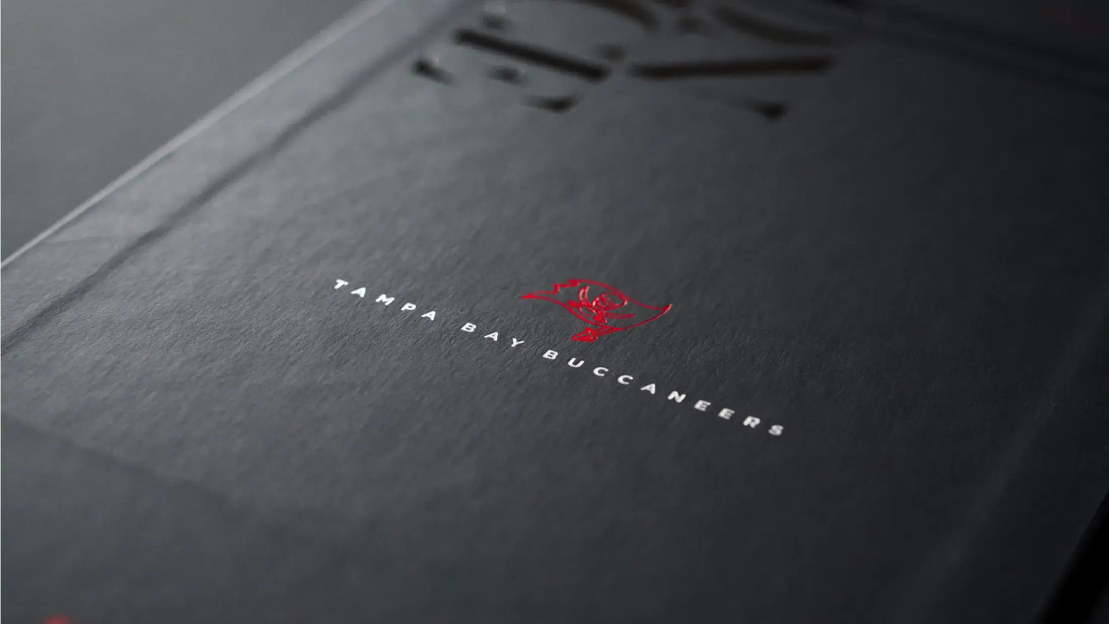 Inside of sleeve - red and silver foil design of TBB logo