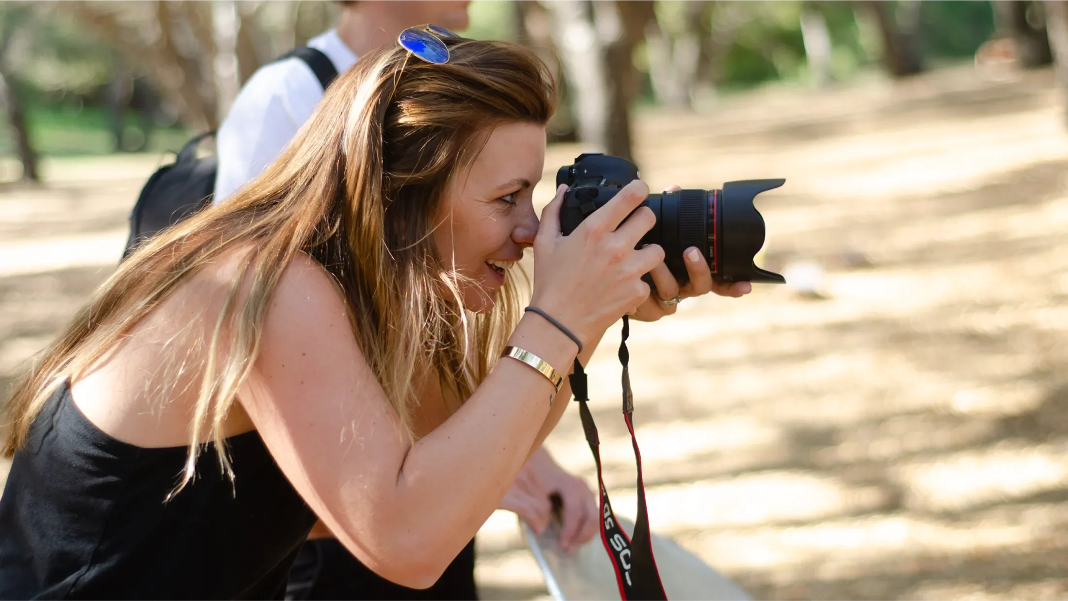 Photographer smiling while taking a picture