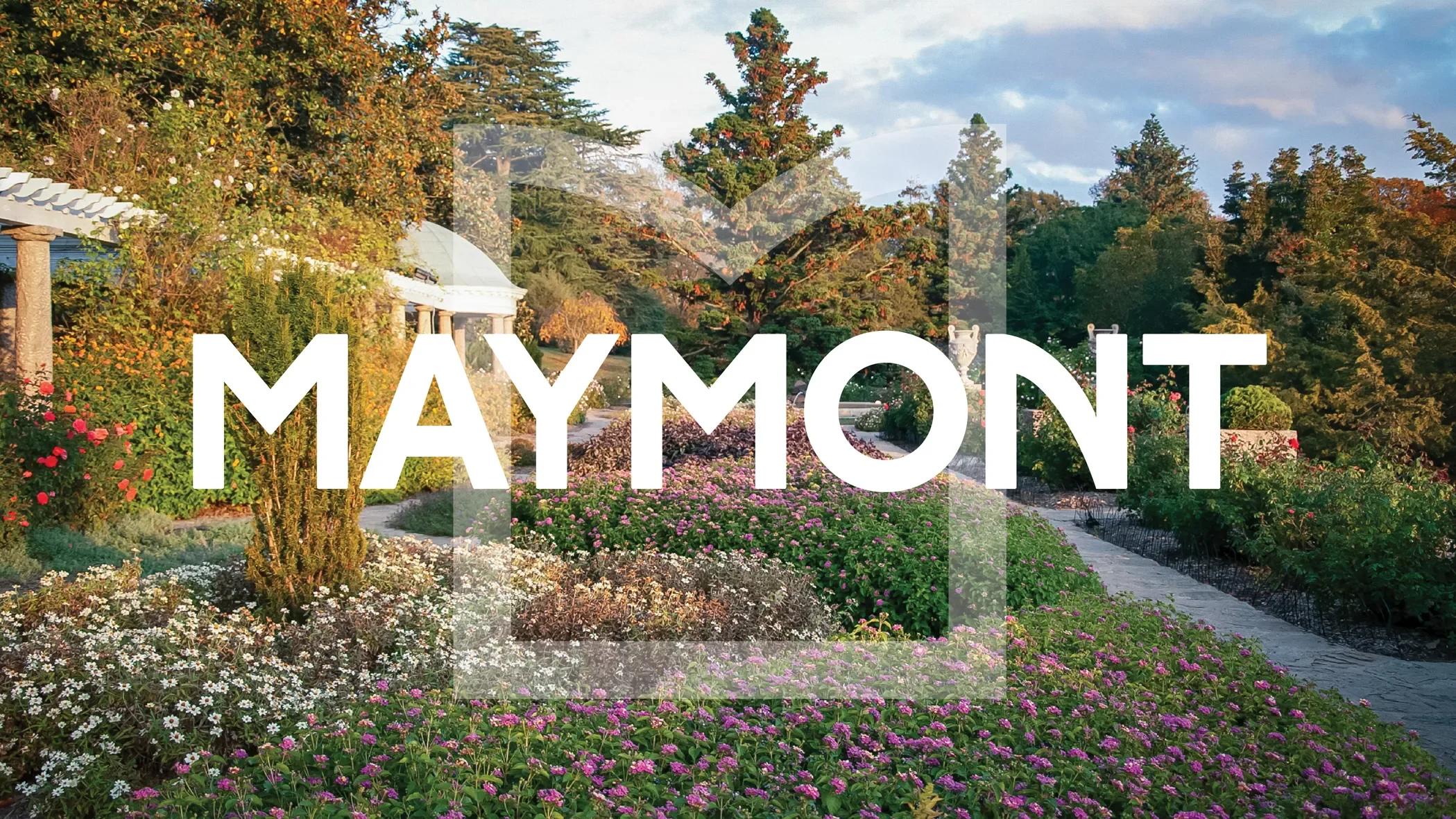 Maymont Logo overtop an image of the colorful italian gardens