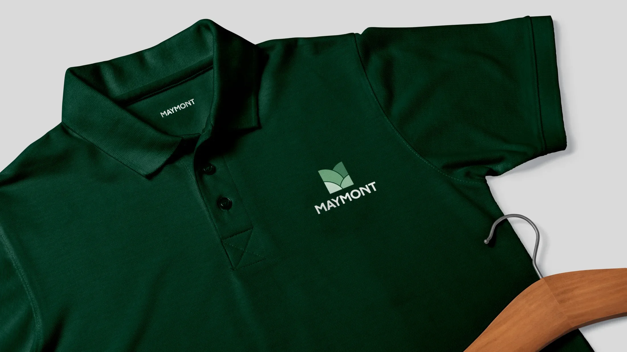 maymont branded polo shirt in dark green with light green logo