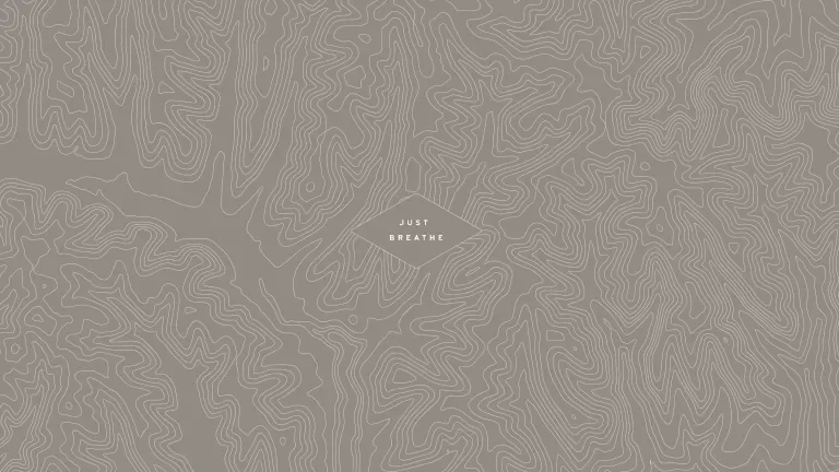 Gray topographical map with a diamond in the middle containing "Just Breathe"