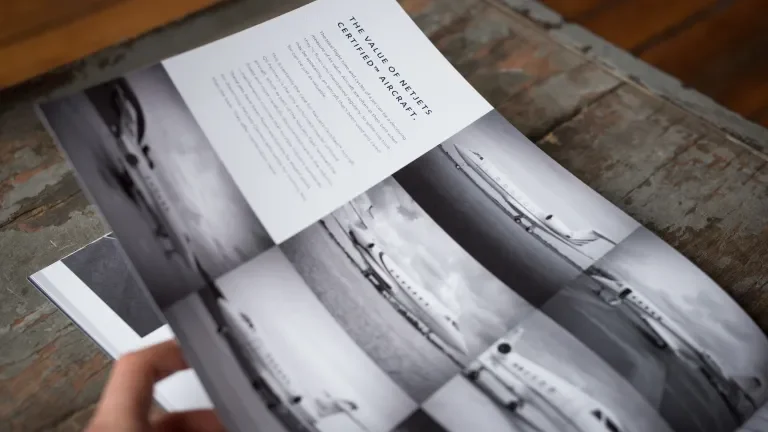 Booklet page showing black and white photos of several jets and reads, "The value of Netjets certified aircraft"