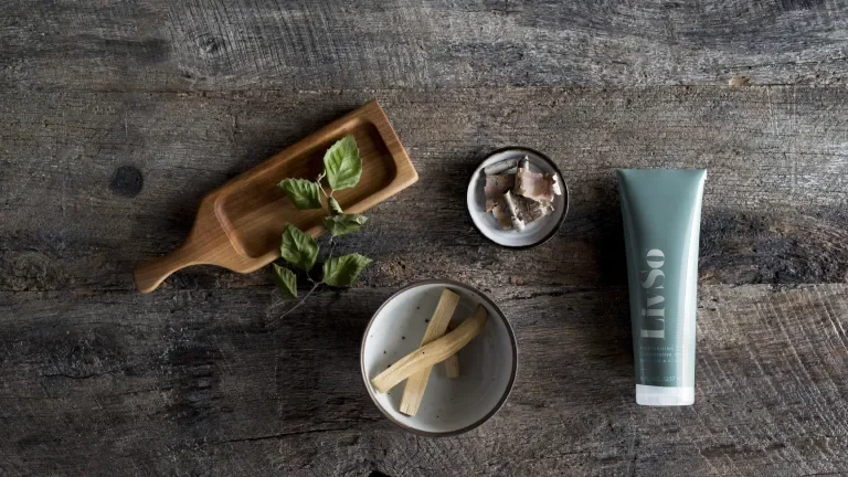 Natural ingredients arranged on a rustic table with a LivSo squeeze bottle