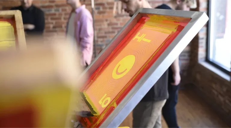 Smiley t-shirt design on a screen-printing press