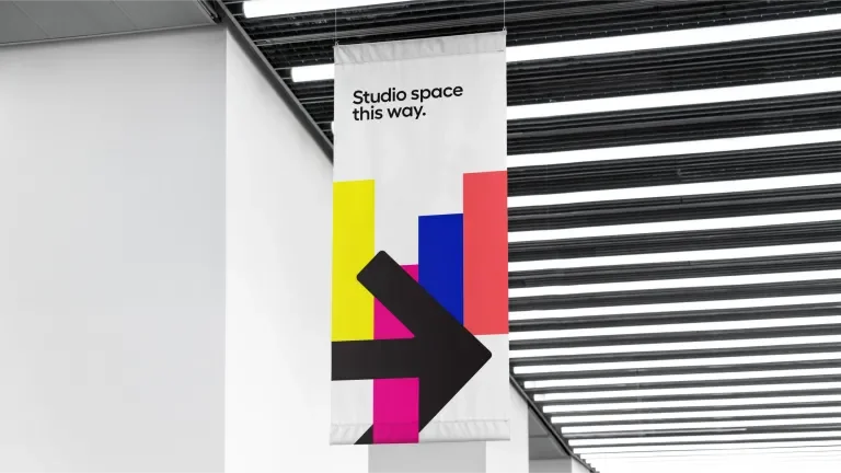 Hi-Lo banner which reads "Studio space this way." hanging from the ceiling 