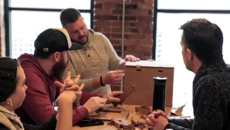 Bonfire Read team looking over a cardboard mockup of the packaging