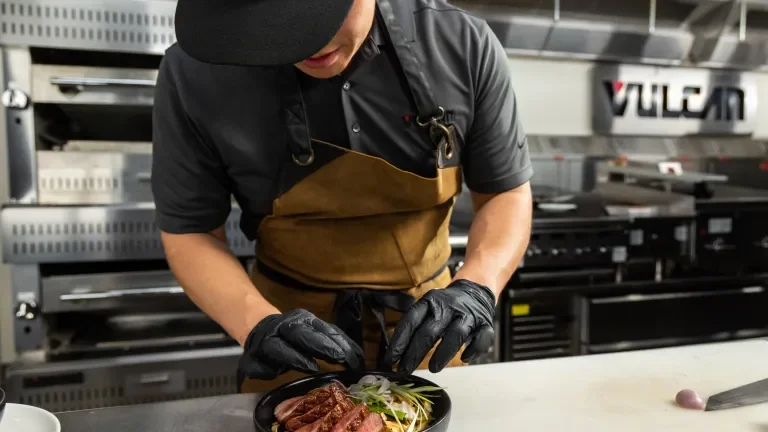Chef in the Vulcan kitchen putting the finished touches on a dish