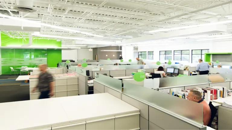 Baesman office busy with people walking around and sitting at their desks