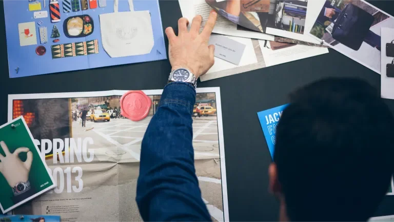 Image showing a man organizing different pieces of paper with graphics on them 