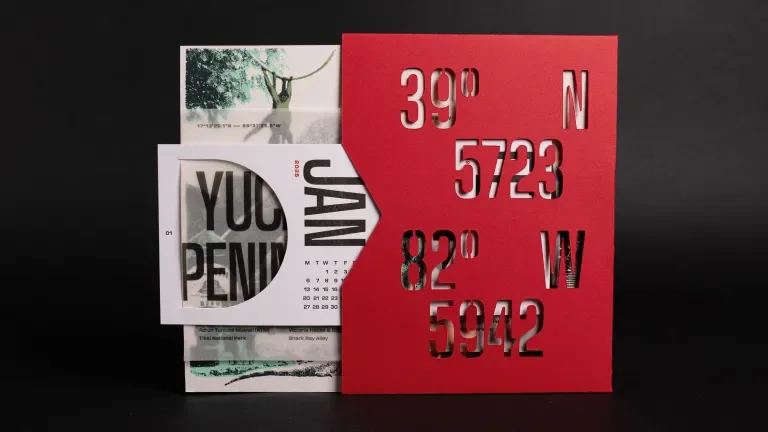 Interior of the desk calendar, showing the January card coming out of the inner sleeve, die cut with coordinates