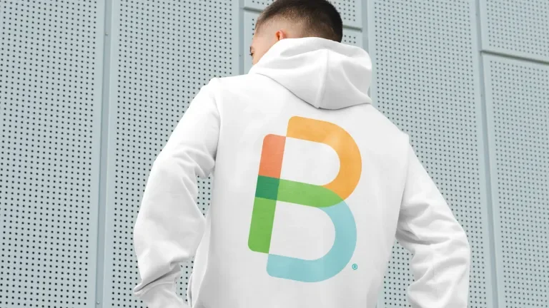 Person with back to camera, wearing white hoodie with Empowered B printed on it.