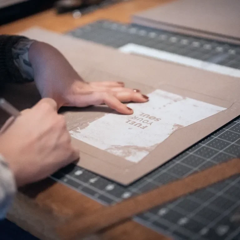 woman cutting out the exterior packaging