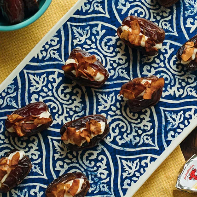 Snacks arranged on a table with Laughing Cow cheese on top