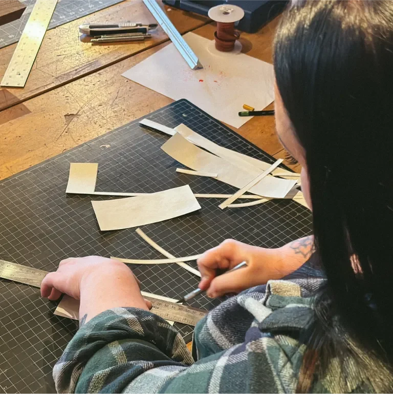 Behind the shoulder of Tara Wren trimming coloring book pages