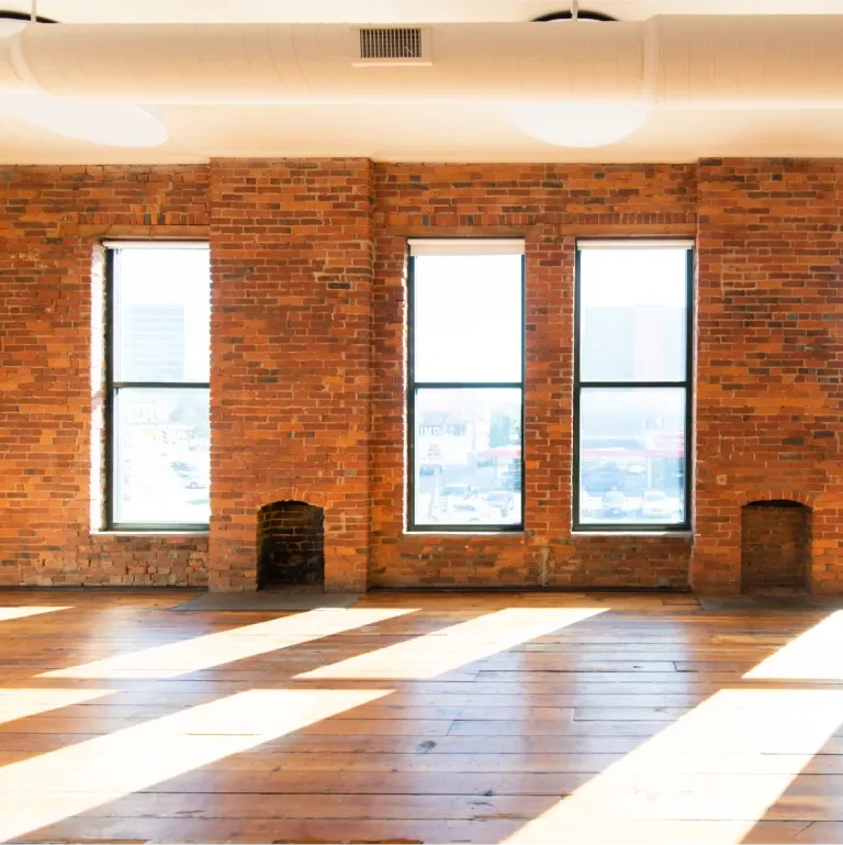 Open studio space with sunlight shining through the back windows