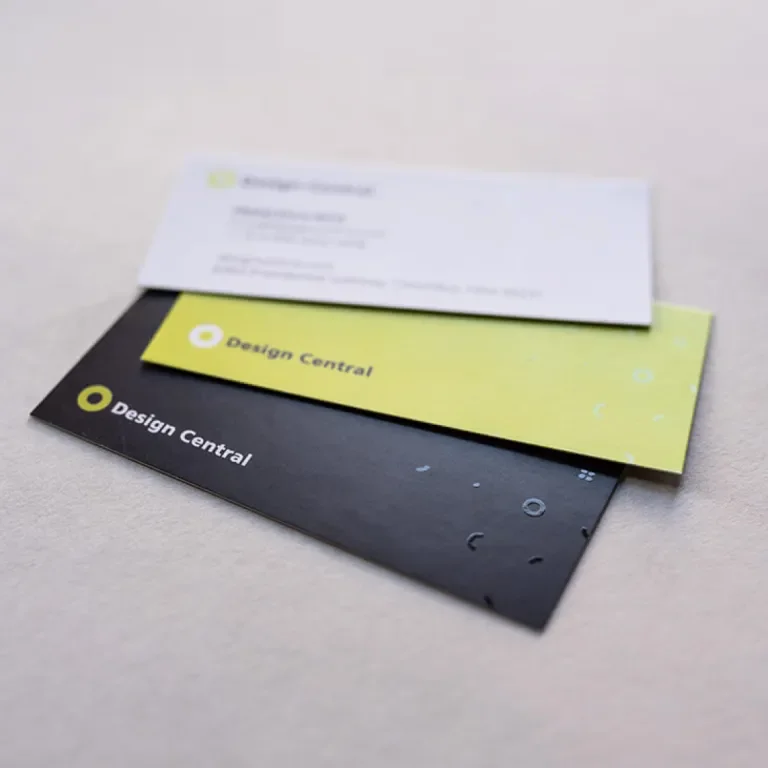 Three Design Central business cards in a stack