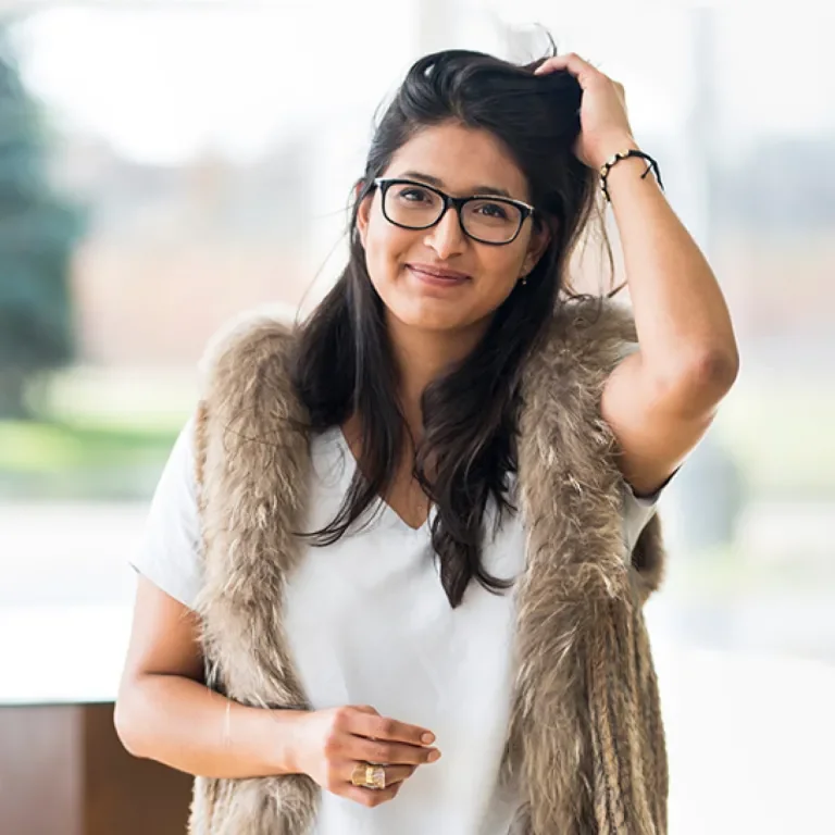 Woman smiling at the camera wearing a fur coat