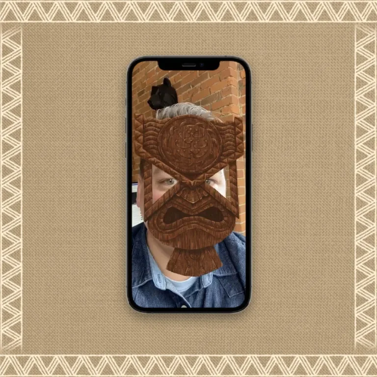 Still of an iPhone screen demoing the tiki AR mask being applied to a person