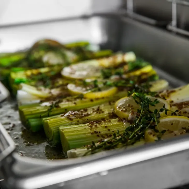Close-up of seasoned celery in a baking dish