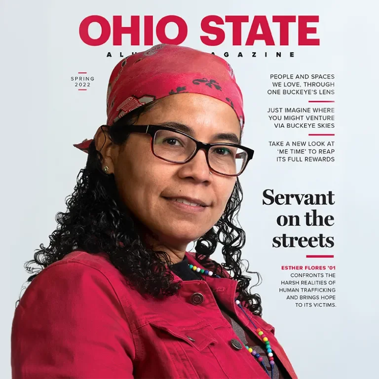 the cover of an ohio state alumni magazine with a woman in a red button up shirt and red baseball cap on