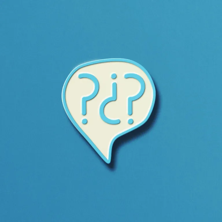 A blue and white enamel pin with question marks inside against a blue background
