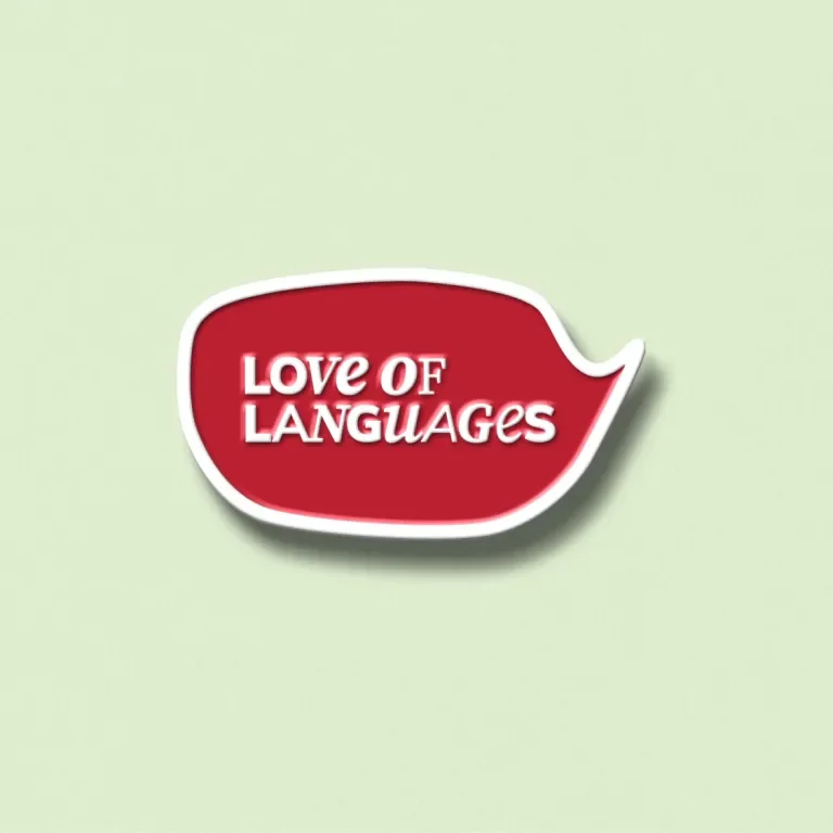 A scarlet and white enamel pin with the Love of Languages type treatment inside against a green background