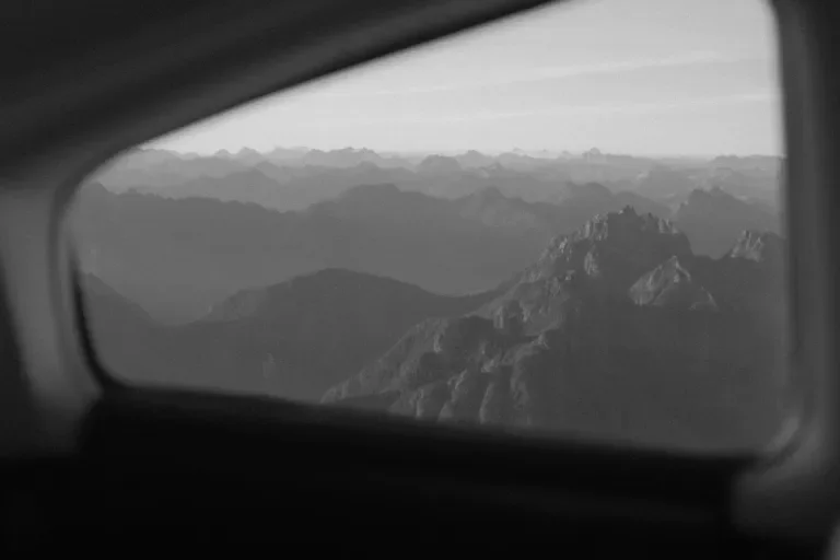 view of mountains through an airplane window