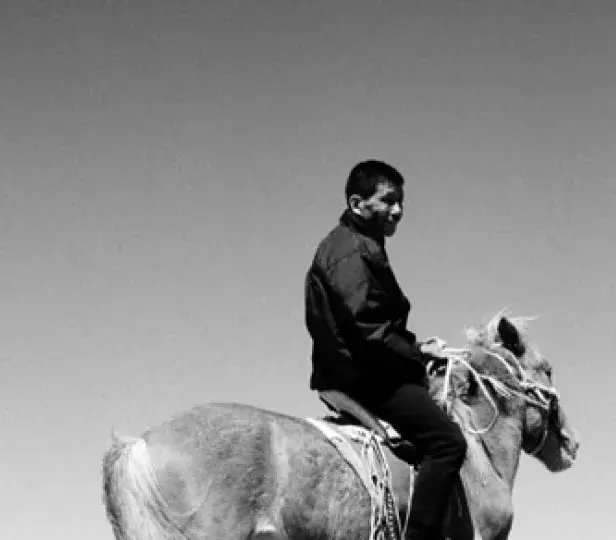black and white of a man riding a horse