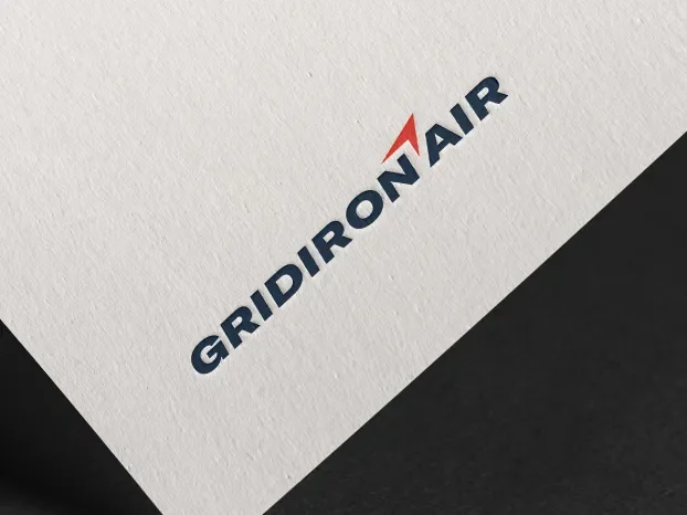 Gridiron Air logo printed on a tilted white textured paper.