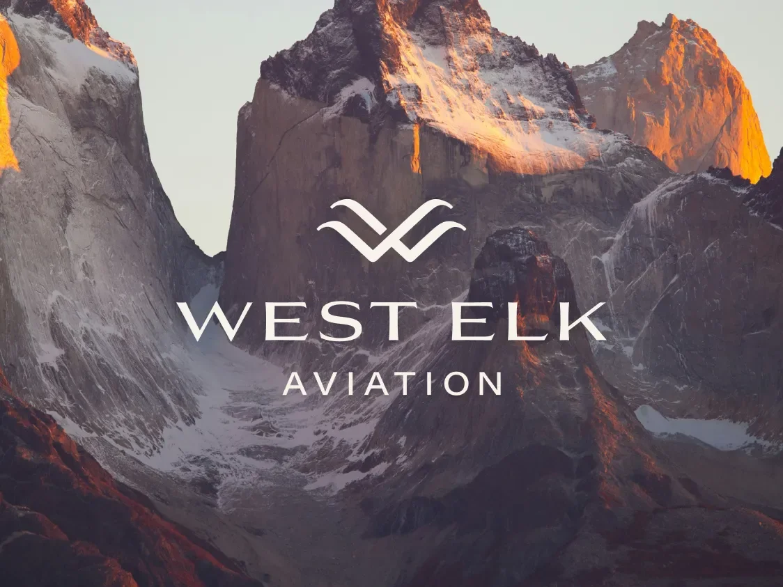 west elk aviation logo against a mountainous backdrop