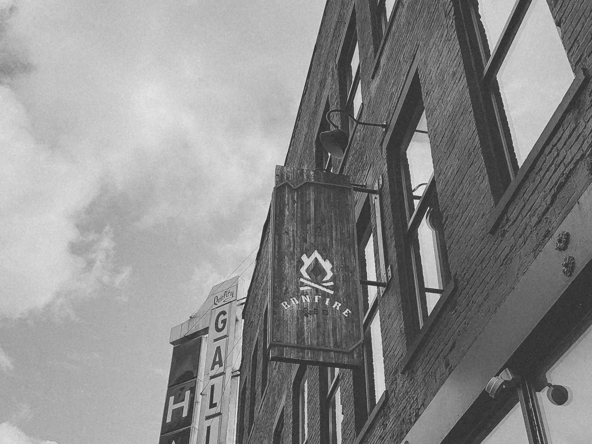 Bonfire Red's building facade against a cloudy sky in black and white